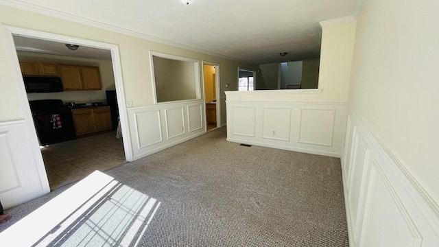 27 Christine Dr, Worcester, MA 01604 - unfurnished room featuring a decorative wall, ornamental molding, light carpet, and a wainscoted wall