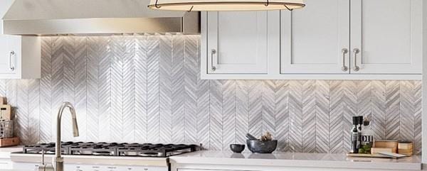 kitchen with ventilation hood and white cabinetry