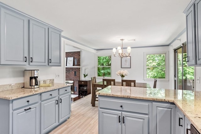 18 Mann St, Bellingham, MA 02019 - kitchen with gray cabinetry, a chandelier, light wood finished floors, a peninsula, and crown molding