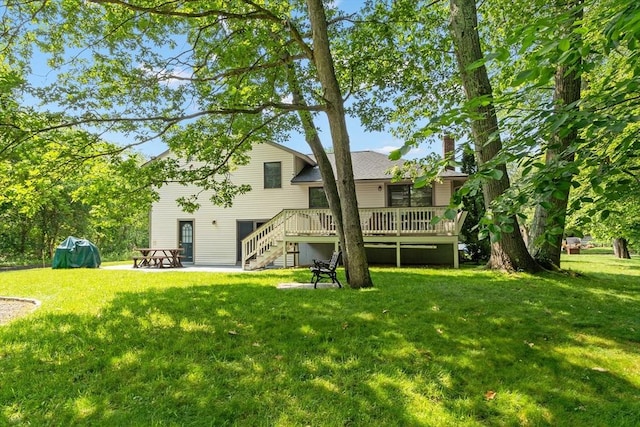 18 Mann St, Bellingham, MA 02019 - back of property featuring stairway, a wooden deck, a yard, a chimney, and a patio