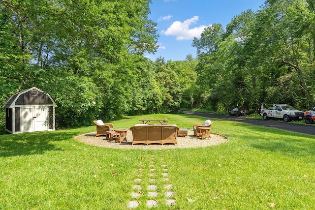 18 Mann St, Bellingham, MA 02019 - view of green lawn featuring a fire pit, a shed, and a forest view