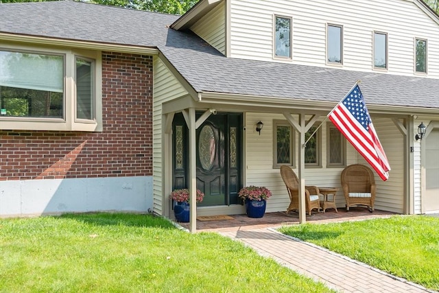 18 Mann St, Bellingham, MA 02019 - view of front of house with brick siding, a front lawn, a shingled roof, and covered porch