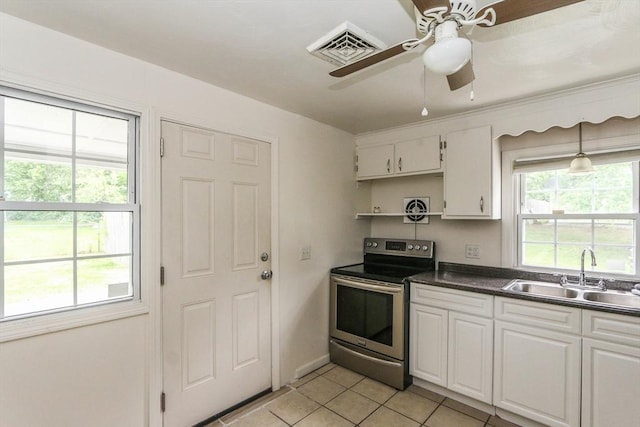 15 Fredette St, Springfield, MA 01109 - kitchen featuring stainless steel range with electric cooktop, a ceiling fan, light tile patterned floors, dark countertops, and white cabinetry