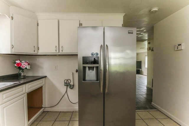 15 Fredette St, Springfield, MA 01109 - kitchen featuring stainless steel refrigerator with ice dispenser, light tile patterned floors, white cabinetry, and dark countertops