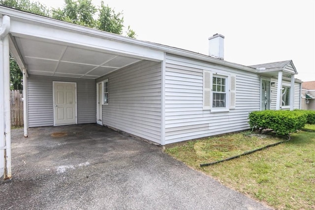 15 Fredette St, Springfield, MA 01109 - view of front of home featuring a carport, a chimney, and asphalt driveway