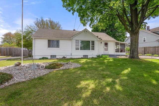 ranch-style home with roof with shingles and a sunroom