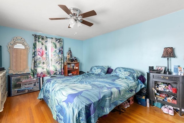 bedroom with wood finished floors and a ceiling fan