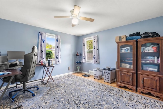 office space with wood finished floors, ceiling fan, and baseboards