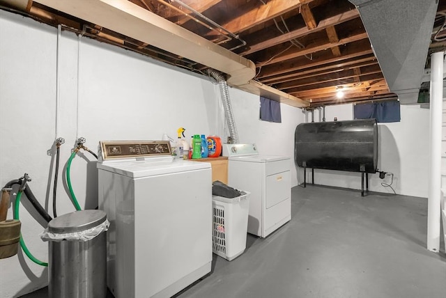 clothes washing area featuring heating fuel and washer and clothes dryer