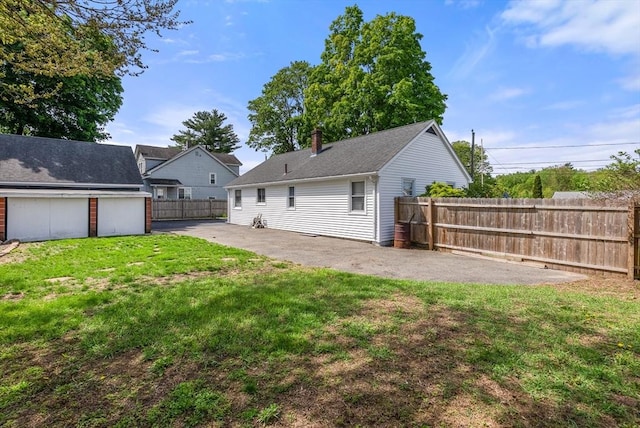 back of property featuring a patio area and a chimney