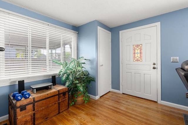 entrance foyer with light wood-style floors and baseboards