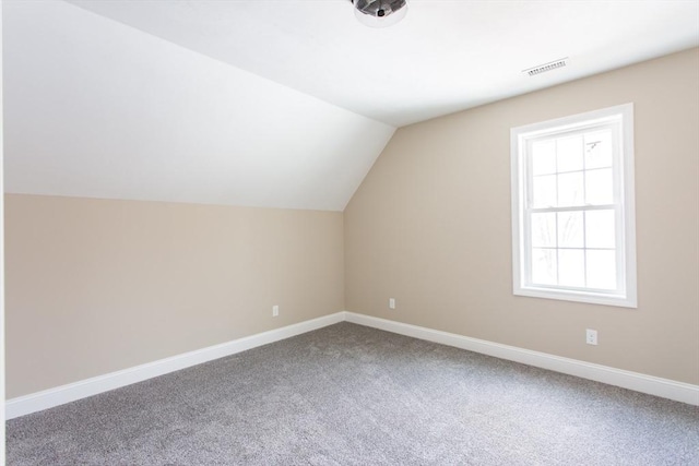 bonus room featuring vaulted ceiling, carpet flooring, visible vents, and baseboards