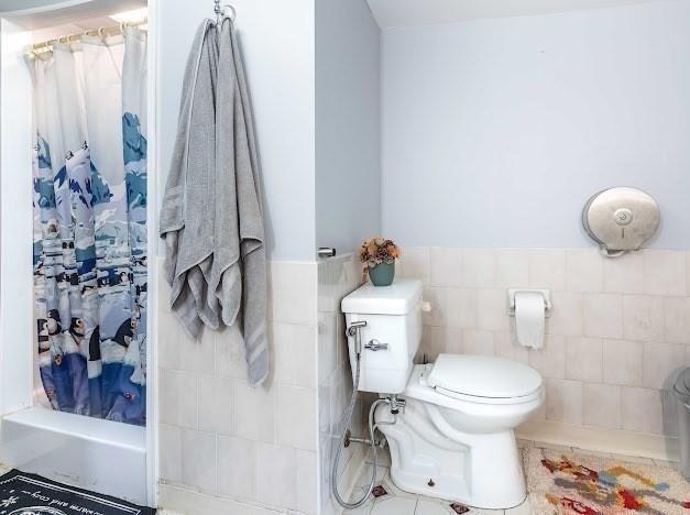 26 Beulah St, Framingham, MA 01701 - full bathroom with tile walls, shower / bath combination with curtain, and wainscoting