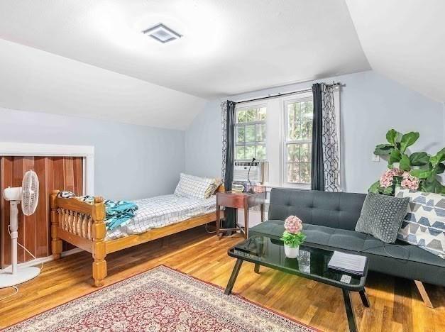 26 Beulah St, Framingham, MA 01701 - bedroom featuring lofted ceiling, wood finished floors, and cooling unit