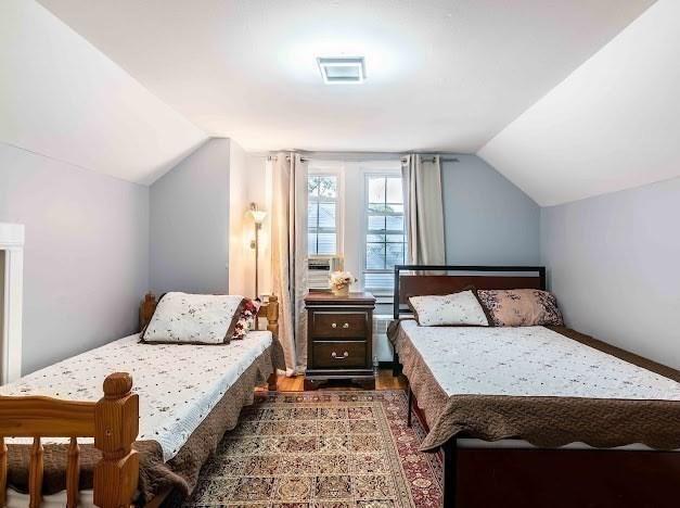 26 Beulah St, Framingham, MA 01701 - bedroom with lofted ceiling and wood finished floors