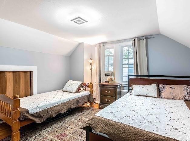 26 Beulah St, Framingham, MA 01701 - bedroom with lofted ceiling and wood finished floors