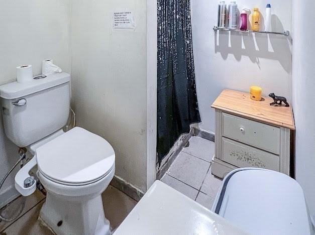 26 Beulah St, Framingham, MA 01701 - full bath with toilet and a shower with curtain