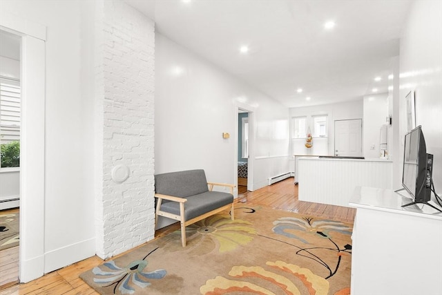 interior space with recessed lighting, baseboards, light wood-style flooring, and a baseboard radiator
