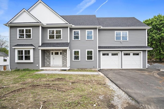 7 Locust St, Woburn, MA 01801 - view of front facade featuring driveway, a garage, board and batten siding, and a shingled roof
