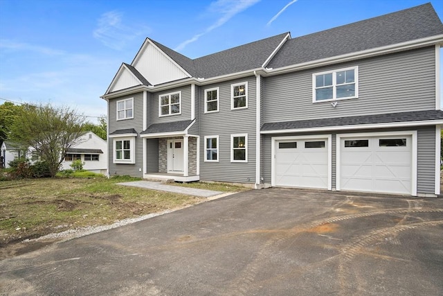 7 Locust St, Woburn, MA 01801 - view of property featuring driveway, an attached garage, and roof with shingles