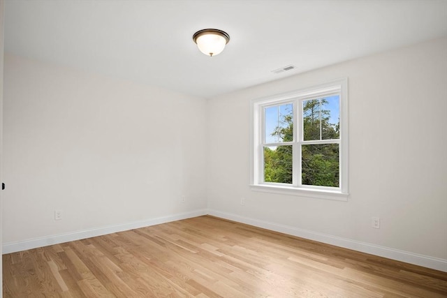 7 Locust St, Woburn, MA 01801 - spare room with baseboards and light wood-type flooring