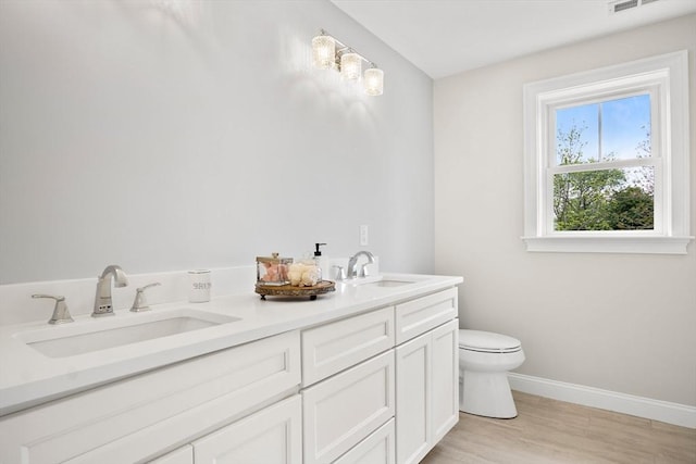 7 Locust St, Woburn, MA 01801 - bathroom with toilet, baseboards, wood finished floors, and double vanity