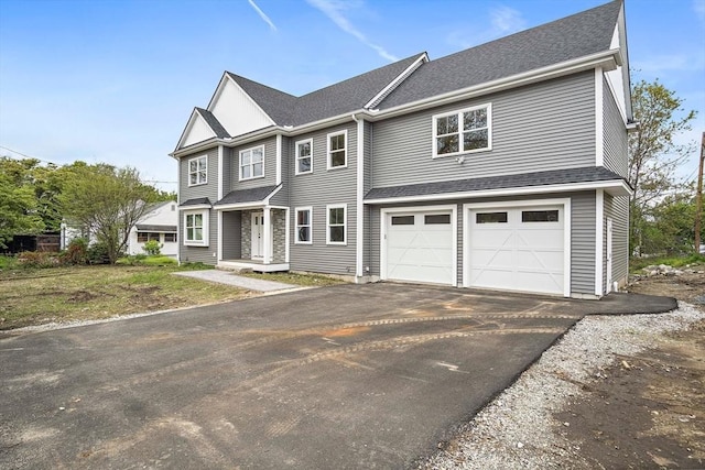 7 Locust St, Woburn, MA 01801 - view of front facade featuring a garage, asphalt driveway, and roof with shingles