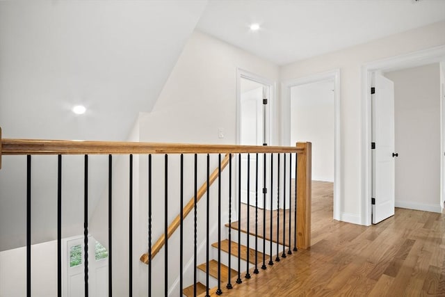 7 Locust St, Woburn, MA 01801 - hallway featuring wood finished floors, an upstairs landing, baseboards, and recessed lighting