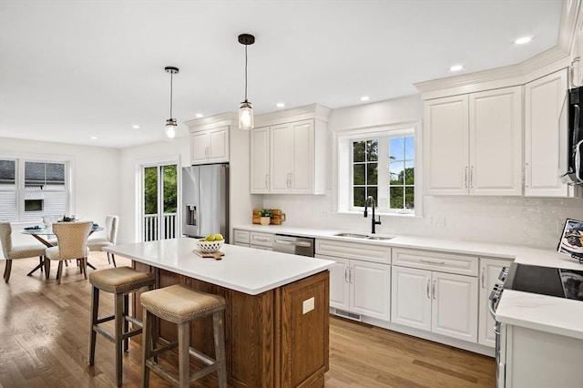 7 Locust St, Woburn, MA 01801 - kitchen with stainless steel appliances, a sink, white cabinetry, decorative backsplash, and recessed lighting