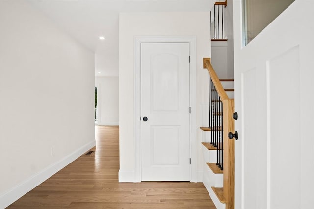 7 Locust St, Woburn, MA 01801 - hall featuring wood finished floors, baseboards, recessed lighting, and stairs