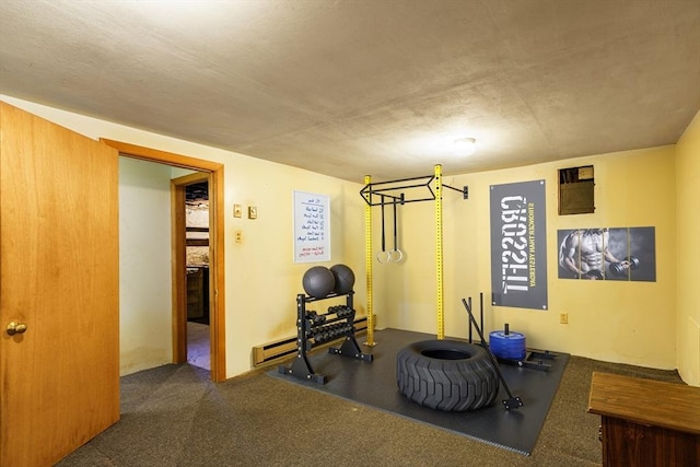 workout room with a baseboard radiator and dark carpet