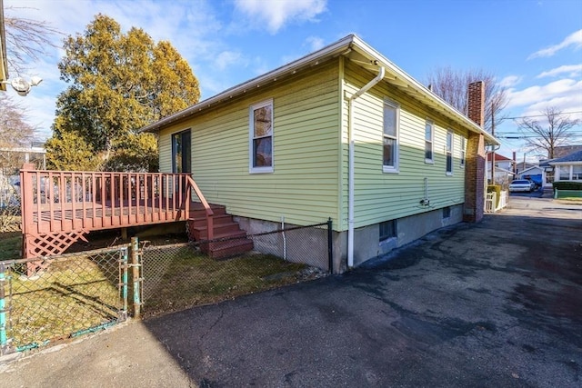 view of side of property featuring a wooden deck