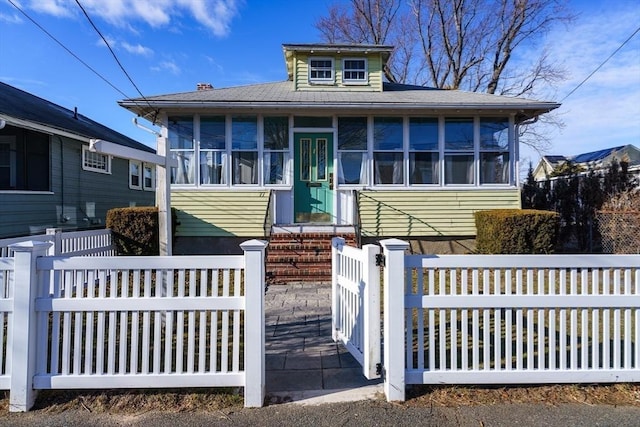 view of front of home featuring a sunroom