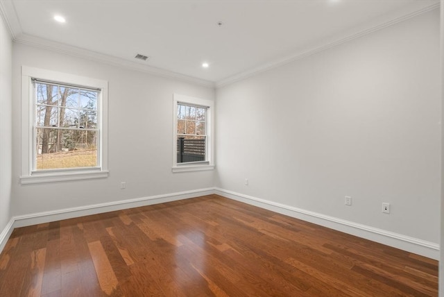 empty room with ornamental molding and wood-type flooring