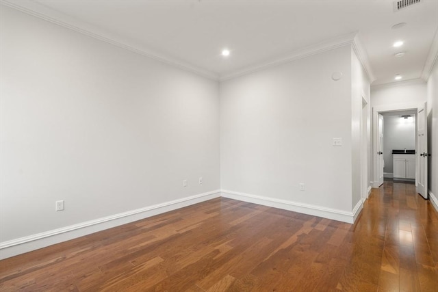 empty room featuring ornamental molding and wood-type flooring