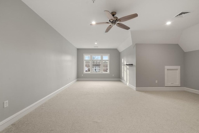 unfurnished living room with ceiling fan, light carpet, and lofted ceiling