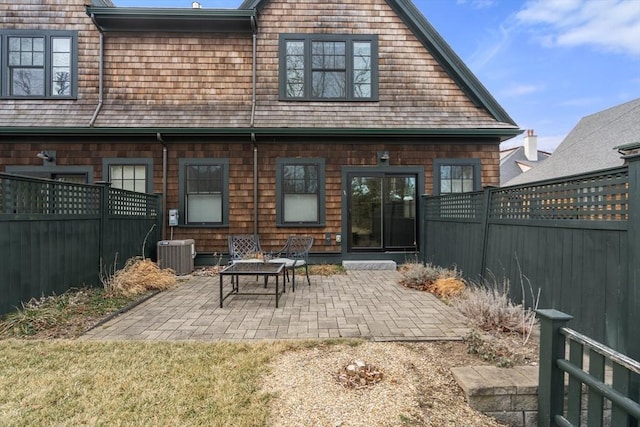 back of property with cooling unit and a patio