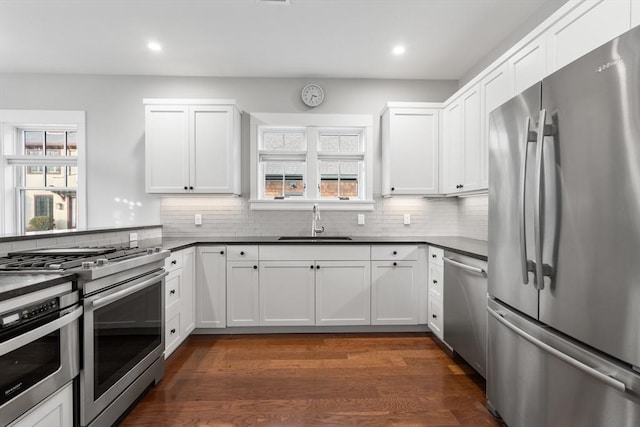 kitchen featuring white cabinets, appliances with stainless steel finishes, and sink