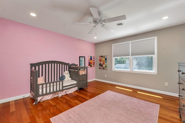 49 Pinehurst Ave, Methuen, MA 01844 - bedroom with baseboards, wood finished floors, recessed lighting, ceiling fan, and a nursery area