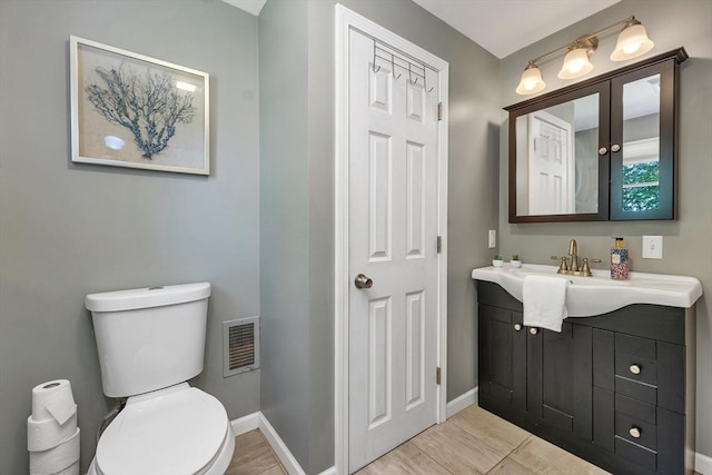49 Pinehurst Ave, Methuen, MA 01844 - bathroom with vanity, toilet, and baseboards