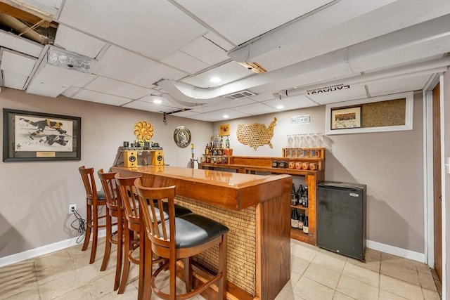 49 Pinehurst Ave, Methuen, MA 01844 - indoor dry bar with refrigerator, baseboards, and light tile patterned floors