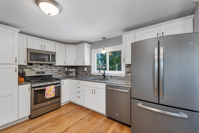 49 Pinehurst Ave, Methuen, MA 01844 - kitchen with appliances with stainless steel finishes, a sink, tasteful backsplash, and white cabinetry