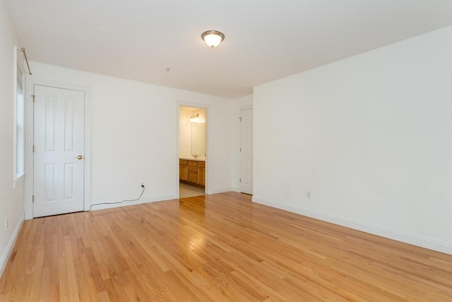 empty room with light hardwood / wood-style flooring