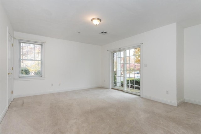 empty room featuring light colored carpet