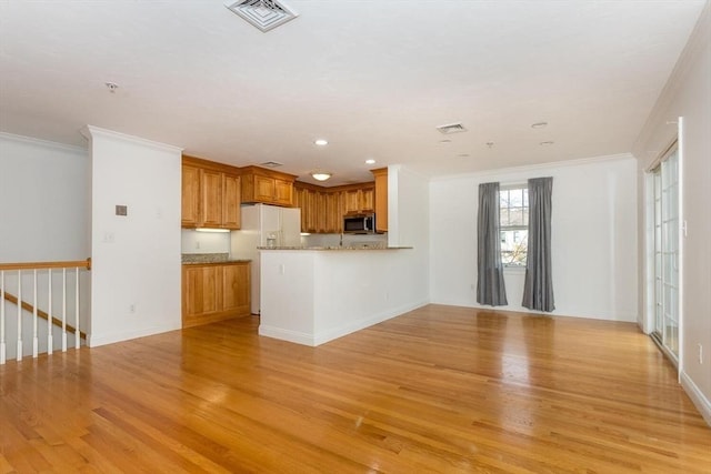 kitchen featuring crown molding, light hardwood / wood-style flooring, white fridge with ice dispenser, and kitchen peninsula