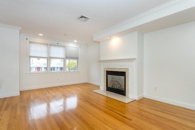 unfurnished living room featuring crown molding and light hardwood / wood-style floors