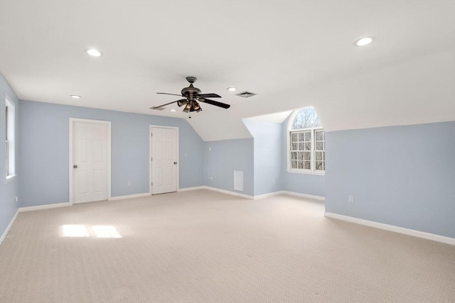 additional living space with visible vents, baseboards, and light colored carpet