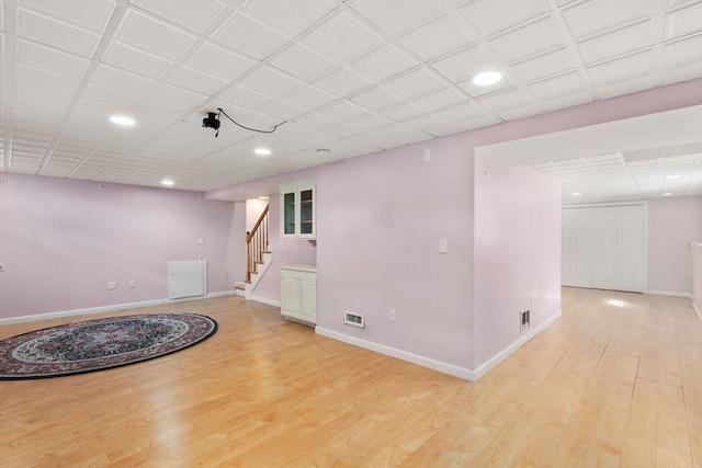 interior space featuring stairway, visible vents, baseboards, and light wood-style floors