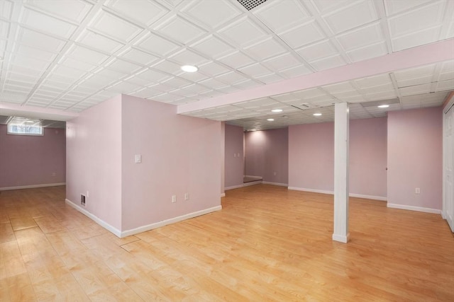 finished below grade area featuring recessed lighting, light wood-type flooring, and baseboards