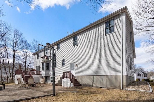 back of house featuring a wooden deck